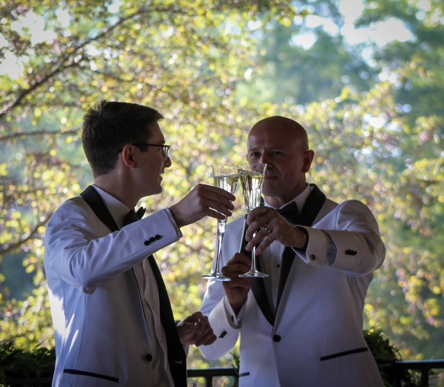 The Jensens toasting with champagne under golden trees